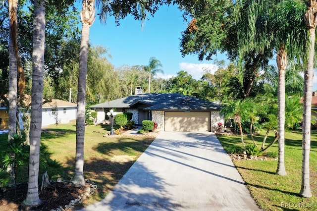 view of front of house with a garage and a front lawn