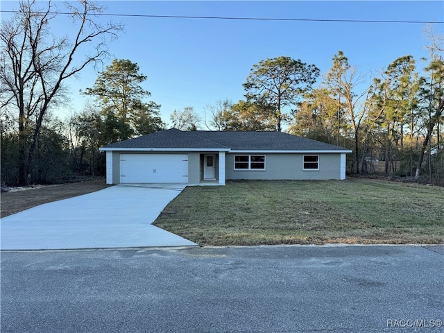 view of front of property with an attached garage, a front lawn, and concrete driveway