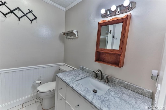 bathroom featuring tile patterned flooring, crown molding, a textured ceiling, toilet, and vanity