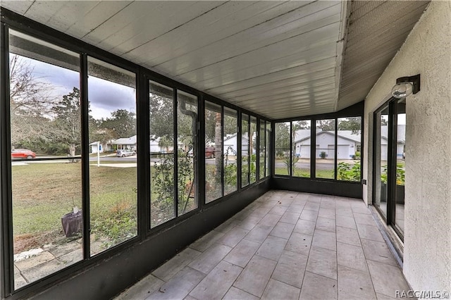 unfurnished sunroom with vaulted ceiling