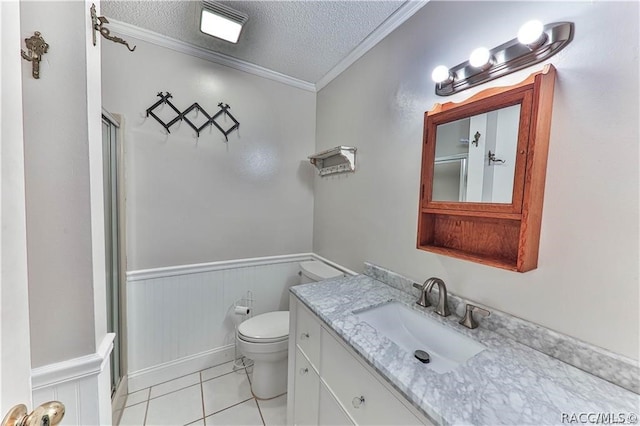 bathroom with vanity, a textured ceiling, tile patterned floors, and ornamental molding