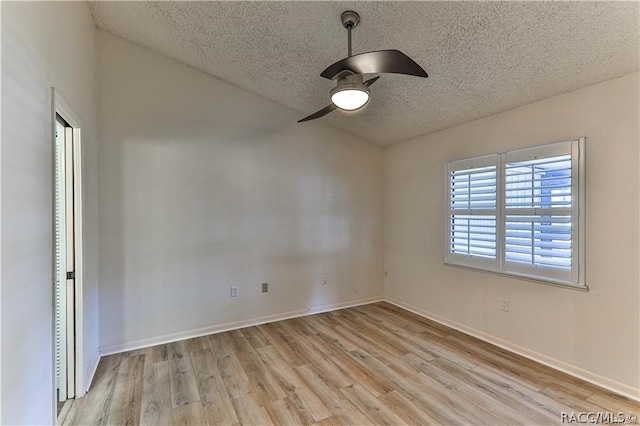 spare room with a textured ceiling, light hardwood / wood-style flooring, and ceiling fan