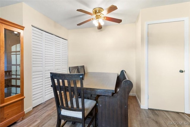9445 W Milwaukee Ct, Crystal River, FL 34428 - dining space with wood finished floors, a ceiling fan, and baseboards