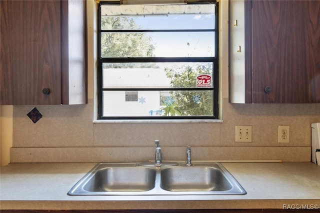 9445 W Milwaukee Ct, Crystal River, FL 34428 - kitchen with a sink, light countertops, and backsplash