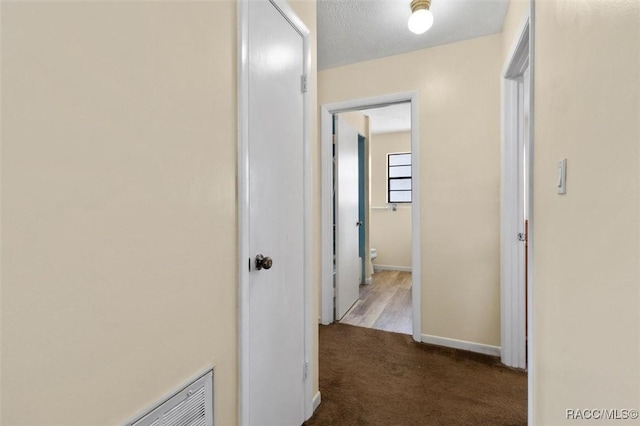9445 W Milwaukee Ct, Crystal River, FL 34428 - corridor with dark carpet and baseboards