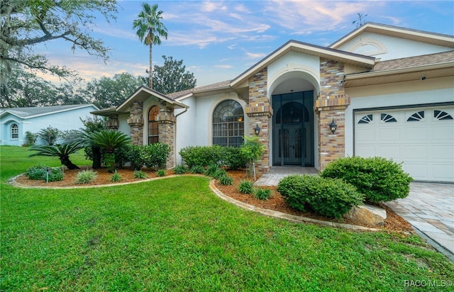 single story home featuring a garage and a front lawn