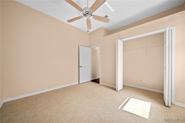 unfurnished bedroom with ceiling fan, a closet, and light tile patterned floors