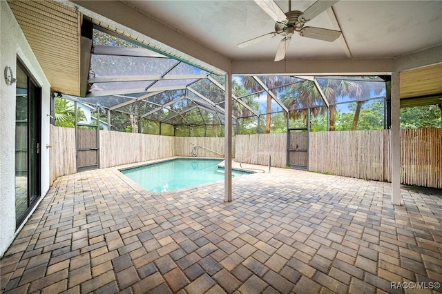 view of swimming pool with a lanai, ceiling fan, and a patio