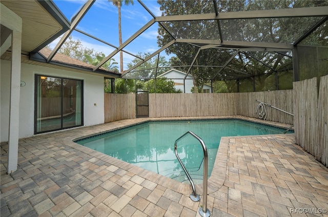 view of swimming pool with a patio and glass enclosure