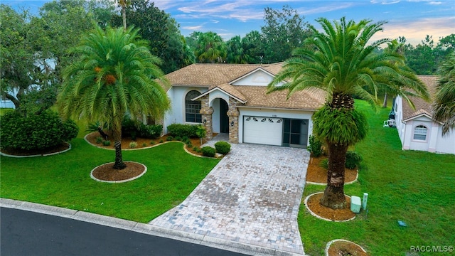 view of front facade with a lawn and a garage