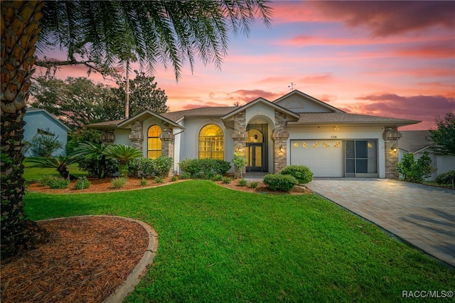 view of front of house featuring a yard and a garage