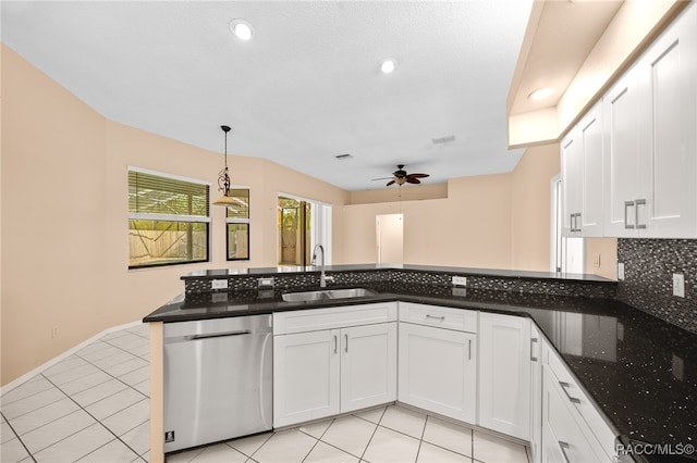 kitchen with pendant lighting, white cabinetry, stainless steel dishwasher, and sink