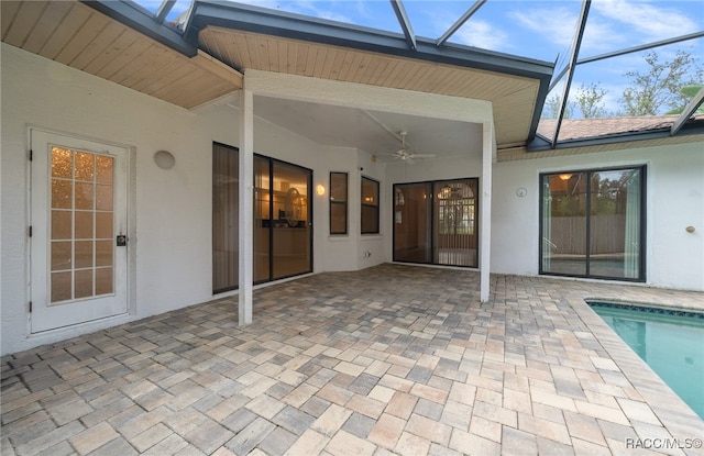 exterior space featuring ceiling fan and a swimming pool