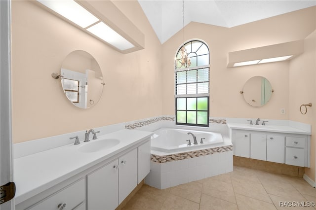 bathroom with tile patterned floors, tiled bath, vanity, and lofted ceiling