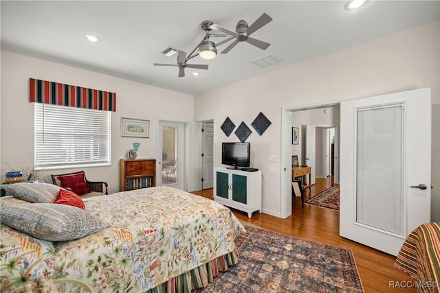 bedroom with ceiling fan and hardwood / wood-style floors