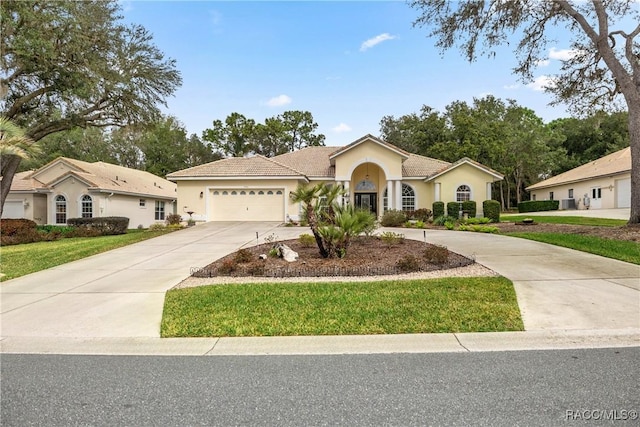 view of front of home featuring a garage and a front yard