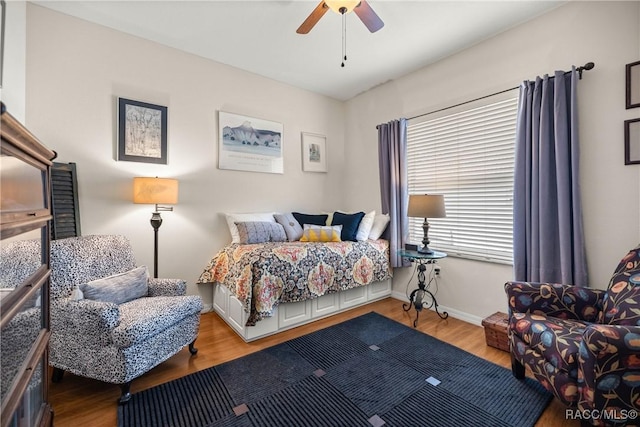 bedroom with ceiling fan and wood-type flooring