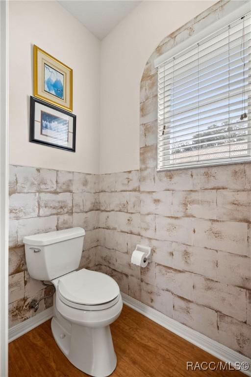 bathroom featuring hardwood / wood-style floors and toilet