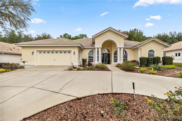 mediterranean / spanish-style home featuring a garage