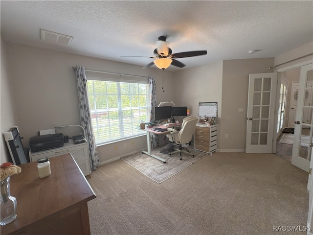 office space with french doors, a textured ceiling, ceiling fan, and baseboards
