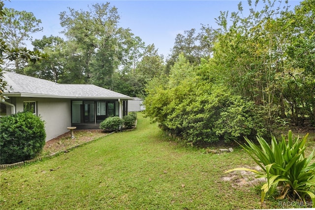 view of yard featuring a sunroom