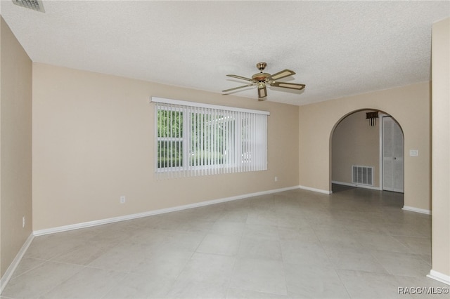 spare room featuring ceiling fan and a textured ceiling