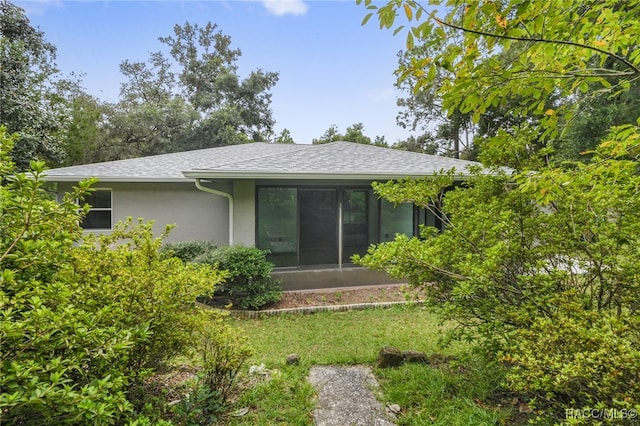 back of property with a sunroom