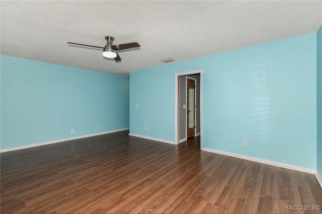 empty room featuring a textured ceiling, ceiling fan, and dark wood-type flooring