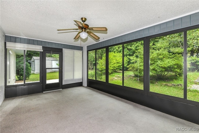 unfurnished sunroom with ceiling fan