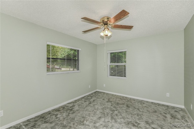 empty room featuring a textured ceiling, light colored carpet, and ceiling fan