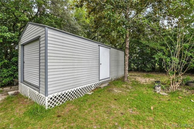 view of outdoor structure featuring a lawn