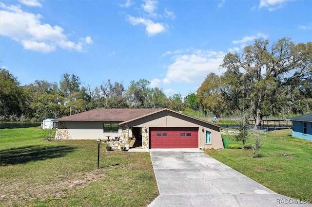 view of front facade featuring a garage, a front yard, stone siding, and driveway