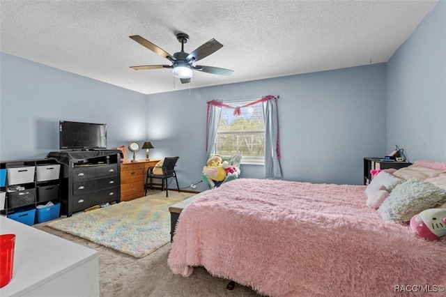 bedroom featuring carpet floors, ceiling fan, and a textured ceiling