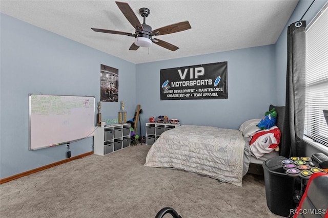 carpeted bedroom featuring baseboards, a ceiling fan, and a textured ceiling