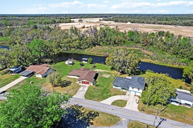 aerial view featuring a water view and a wooded view