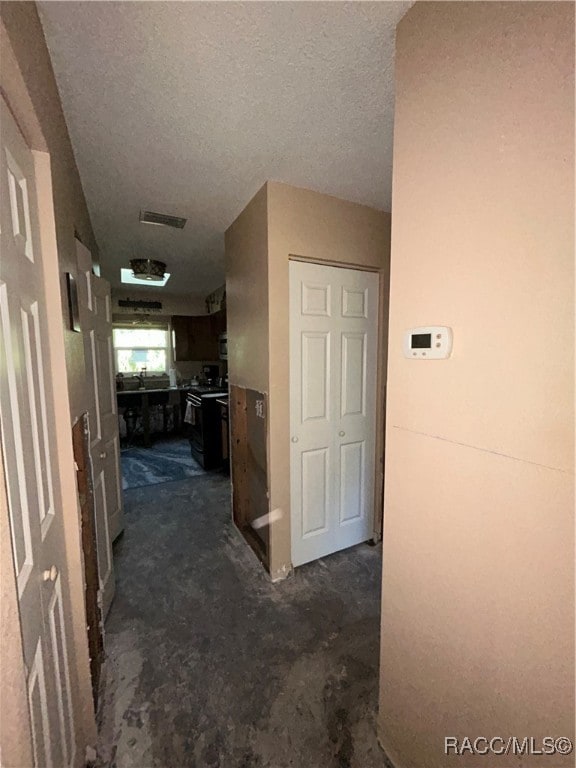 hallway with a textured ceiling