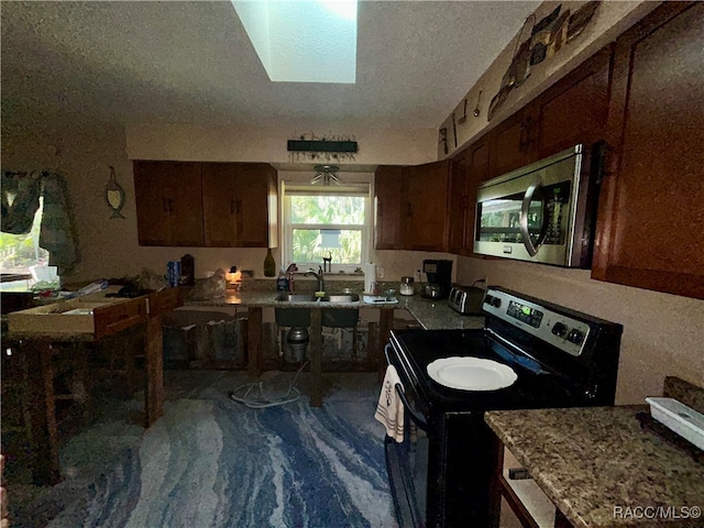 kitchen featuring a textured ceiling, dark carpet, sink, and black electric range