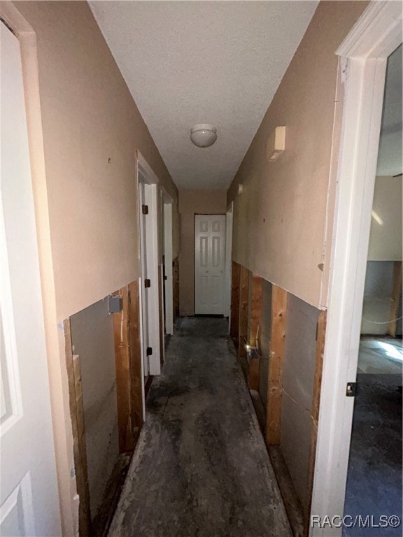 hallway with a textured ceiling