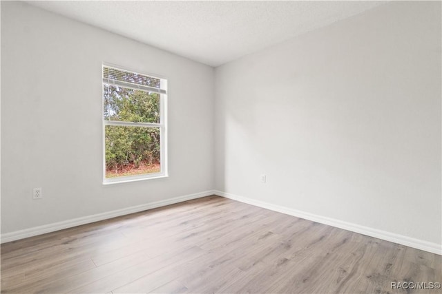 3143 Grayton Dr, Spring Hill, FL 34609 - empty room with wood finished floors and baseboards