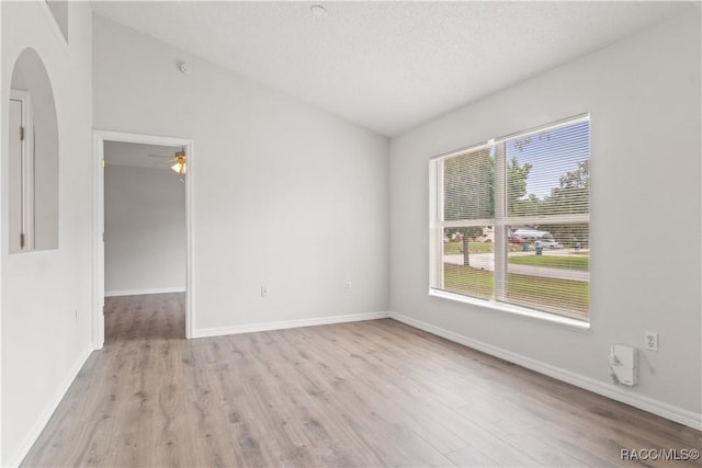 3143 Grayton Dr, Spring Hill, FL 34609 - unfurnished room featuring arched walkways, wood finished floors, ceiling fan, and vaulted ceiling