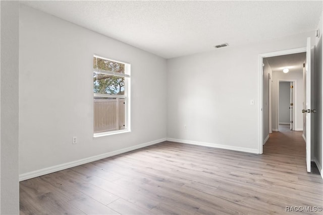 3143 Grayton Dr, Spring Hill, FL 34609 - spare room with wood finished floors and a textured ceiling