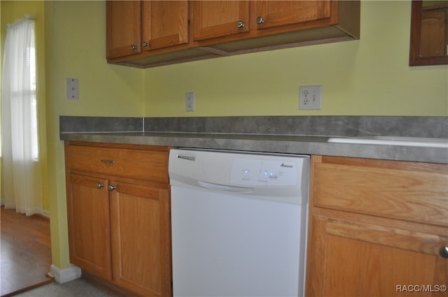 kitchen with dishwasher, light hardwood / wood-style floors, and stainless steel counters