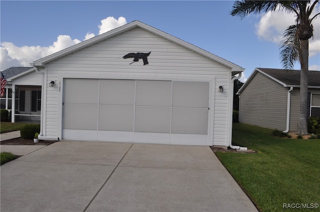 garage featuring a lawn