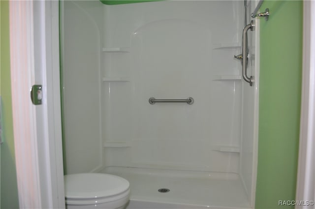 bathroom with toilet and walk in shower