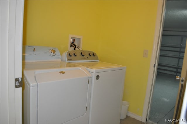 washroom with washing machine and clothes dryer