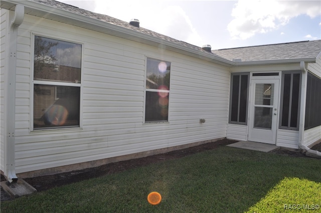 view of property exterior featuring a lawn