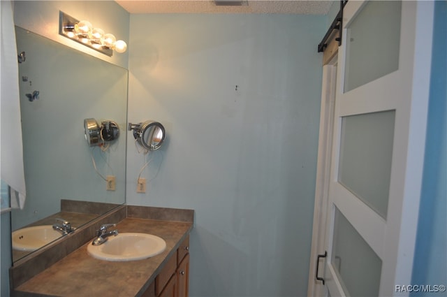 bathroom featuring vanity and a textured ceiling