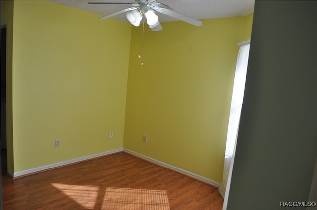 empty room with hardwood / wood-style floors, a textured ceiling, and ceiling fan