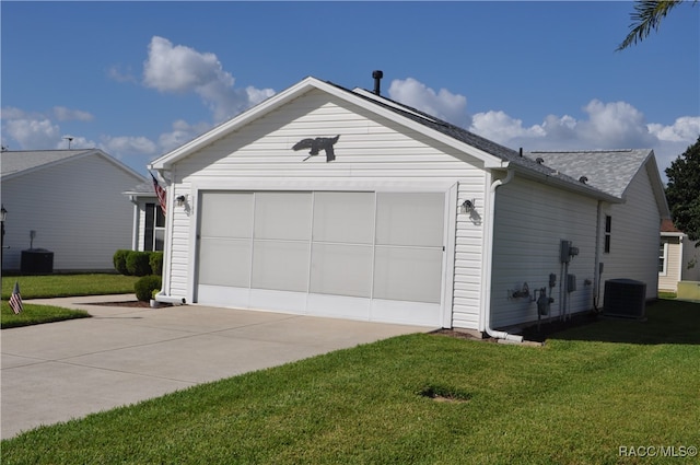 exterior space with a lawn, central AC, and a garage