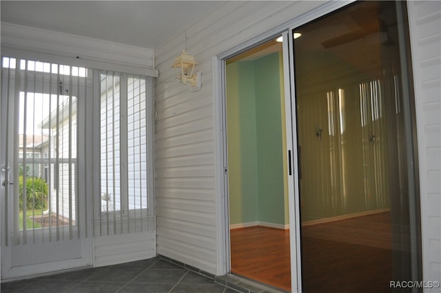 entryway with dark tile patterned flooring